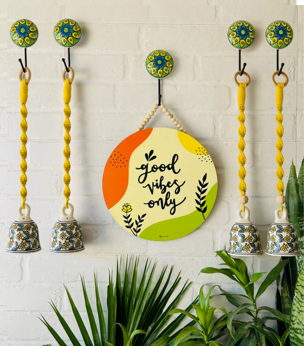Good vibes only wall set up with four lemon yellow macrame bells and ceramic hooks