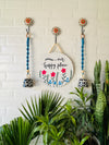 Our happy place wall set up with two blue macrame bells