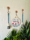 Our happy place wall set up with two blue macrame bells