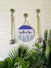 Welcome wall set up with two green macrame bells