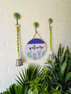 Welcome wall set up with two green macrame bells