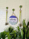 Welcome wall set up with two green macrame bells