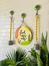 Good vibes only wall set up with two lemon yellow macrame bells